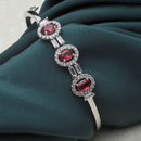 Rhodium Plated Silver Toned Oval Shaped Red American Diamond Studded Kada Bracelet