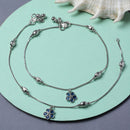 Rhodium Plated Silver Toned Flower Shaped Royal Blue Cubic Zirconia studded Charm Anklets